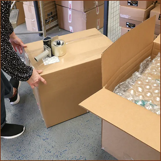 Picture of a packaging box being taped up